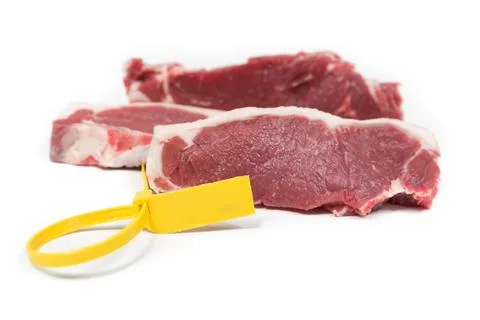 Three pieces of calf with a yellow label on a white background Stock Photos
