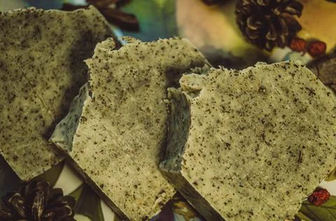 Three pieces of handmade soap lying on the table. The focus is set on the top Stock Photos