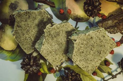 Three pieces of handmade soap lying on the table. The focus is set on the top Stock Photos
