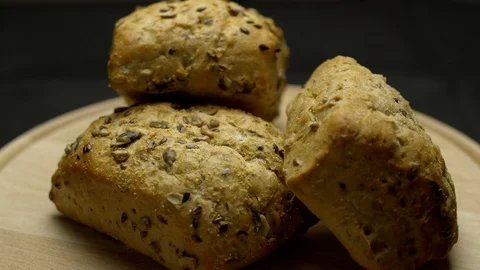 Three pieces of integral bread on a wooden board Stock Footage 106753663
