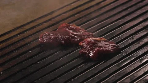 Three Pieces of meat toss on the grill. Cook grilling fresh beef Putting meat on Stock-Footage 232380175