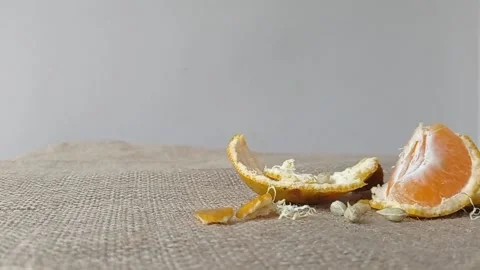 Three pieces of orange fruit on a brown table Stock Footage 150523132