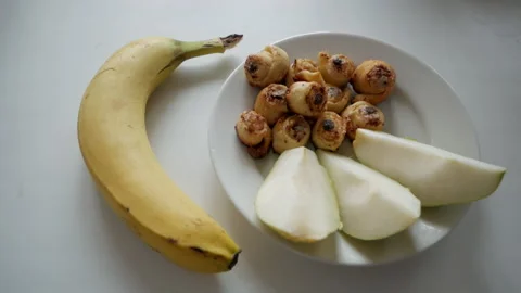 Three pieces of pear, cinnamon rolls and banana Video stock 153436247