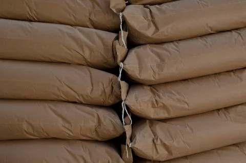 Three piles of big sacks at warehouse in modern factory Stock Photos