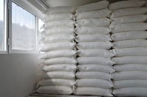 Three piles of big sacks at warehouse in modern factory Stock Photos