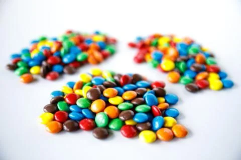 Three piles of colored smarties Stock Photos