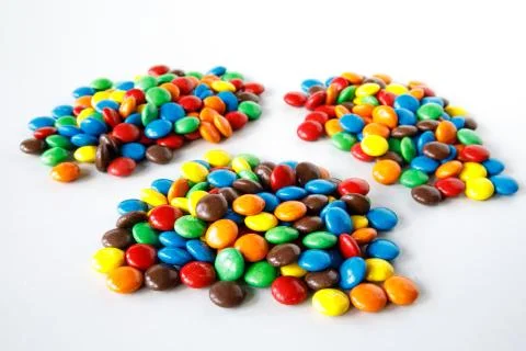 Three piles of colored smarties Stock Photos