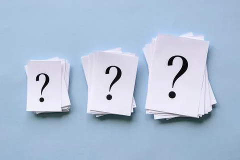 Three piles of question marks printed on paper Stock Photos