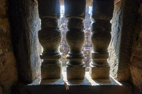 Three pillars are visible through a window Stock Photos