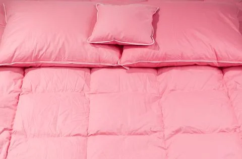 Three pillows on big duvet without cover Stock Photos
