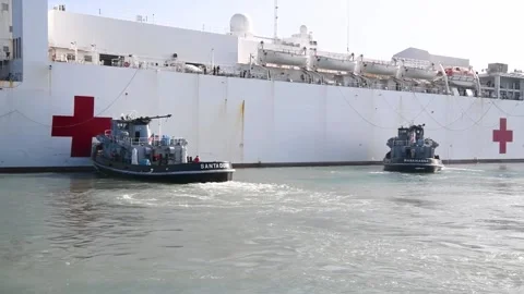 Three pilot ships guiding U.S. Navy hospital ship USNS Comfort (T-AH-20)  Stock Footage 227138793