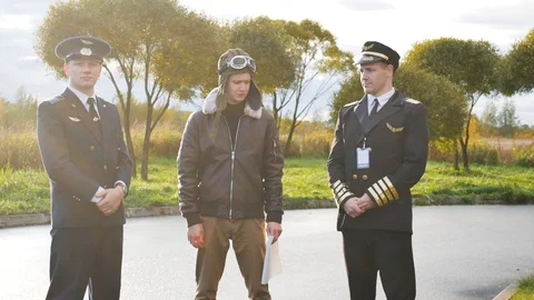 Three pilots briefing a flight plan    documents uniform  weather 스톡 동영상 117305031