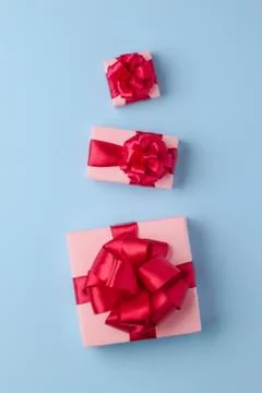 Three pink boxes on a light blue paper background. Stock Photos