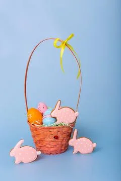 Three pink gingerbread in the form of a rabbit and a basket with decorative Stock Photos