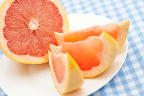 Three pink grapefruit segments Фото