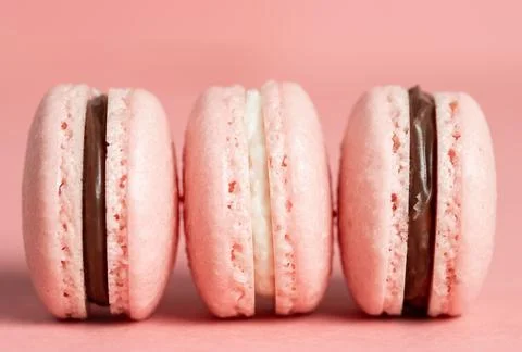 Three pink macaron on a pink background Foto stock