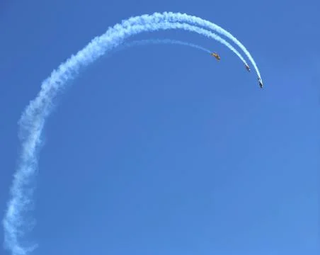 Three planes looping against a blue sky Foto stock