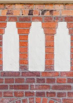 Three Plaster Columns in Red Brick Wall  Compressed Urban Faade Stock-Fotos