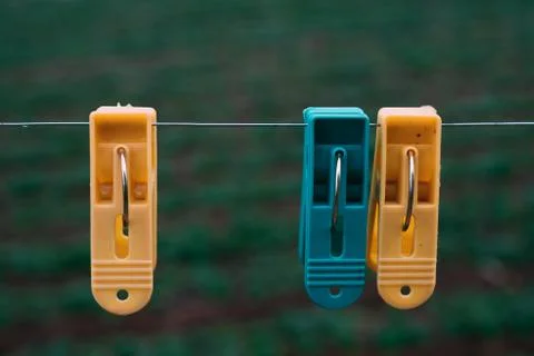 Three plastic clothes pegs Stock Photos