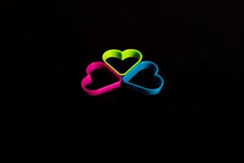 Three plastic cookie cutters, blue, pink and green, for making cookies in the Stock Photos