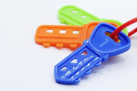 Three plastic toy keys in different colors on a white background Stock Photos