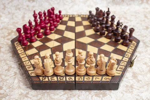 Three player chess board with black, white and red color pieces, on hexagon.. Foto stock