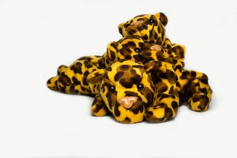Three playful stuffed leopard soft toys isolated on a plain white background Stockfoto's
