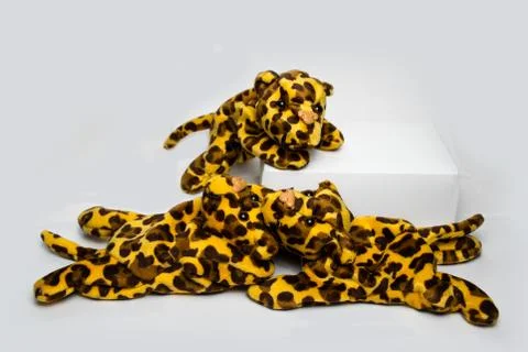 Three playing stuffed leopard soft toys isolated on a plain white background Stock Photos