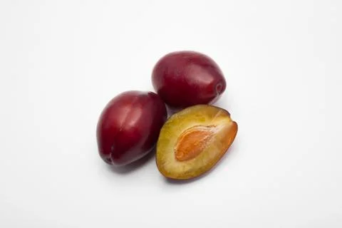 Three plums on a white background Stock Photos