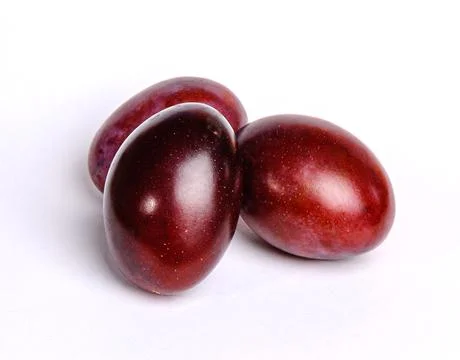 Three plums on a white background Stock Photos