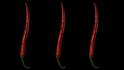 Three pods of red hot pepper rotate on a black background Stockbeeldmateriaal 126083327