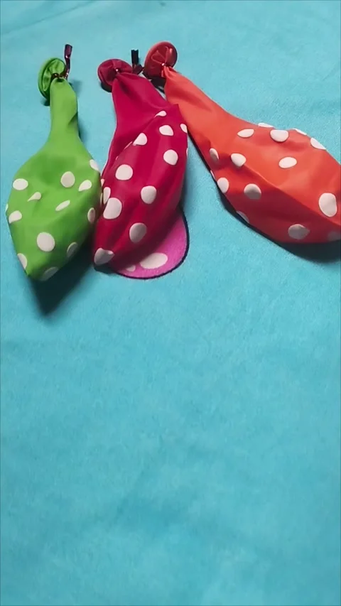 Three Polka Dot Balloons in Orange, Red, and Green Colors Stock Footage 296035848