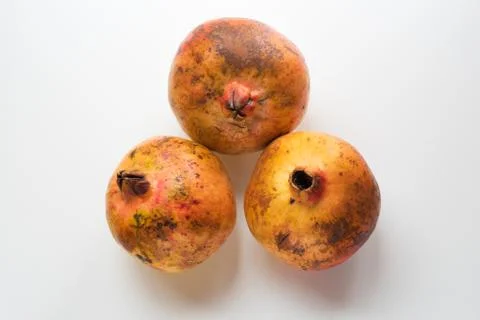 Three pomegranates on a white surface 写真素材