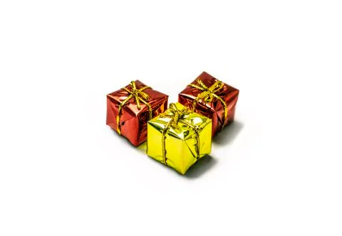 Three presents, two red and one yellow with ribbons isolated on white backgro Stock Photos