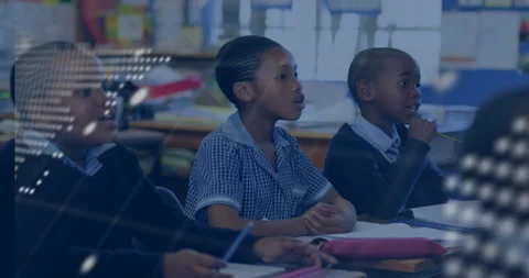 Three primary students in classroom with map code overlay shifting to reveal Stock Footage 316185265