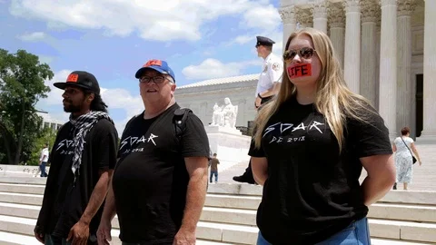 Three Pro-Life Demonstrators wearing Red Tape that says Life Stock Footage 91715088