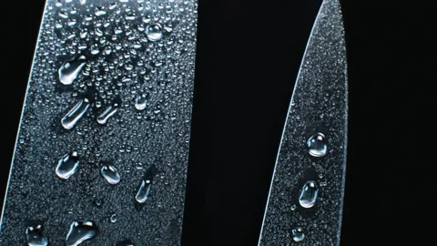 Three professional chef knives in water drops Stock Footage 133717634