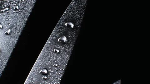 Three professional chef knives in water drops Stock Footage 133720480