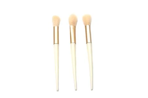 Three professional makeup brushes with soft fluffy bristles, elegant gold ferrul Stock Photos
