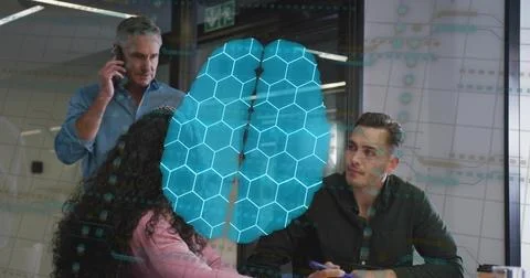 Three professionals collaborating in office projecting hexagonal brain hologram Stock Photos