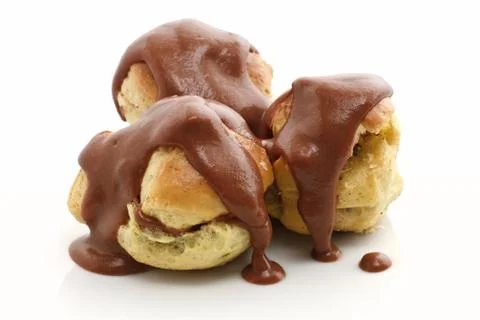 Three profiteroles over white Stock Photos