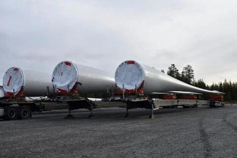 Three propeller blades on  trailers ready to be mounted on a wind turbine Stock Photos