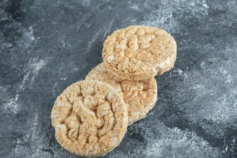 Three puffed rice cakes on marble background Stock Photos