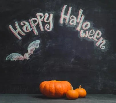 Three pumpkins on a black background Stock Photos