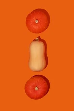 Three pumpkins on a orange background top view Stock Photos