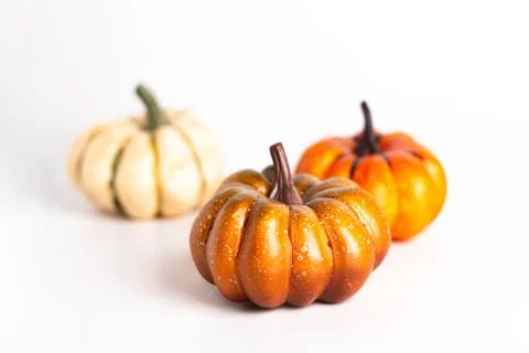 Three pumpkins on white background close up photo Fotos de archivo