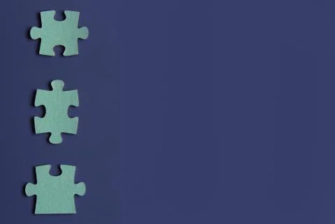 Three puzzle pieces on blue background.copyspace for text. Stock Photos