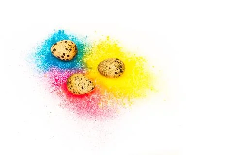 Three quail eggs on a background of bright blue and yellow colou Stock Photos