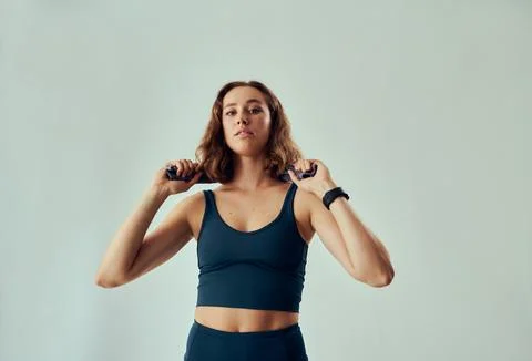 Three quarter length of determined young caucasian woman in sportswear with Stock Photos