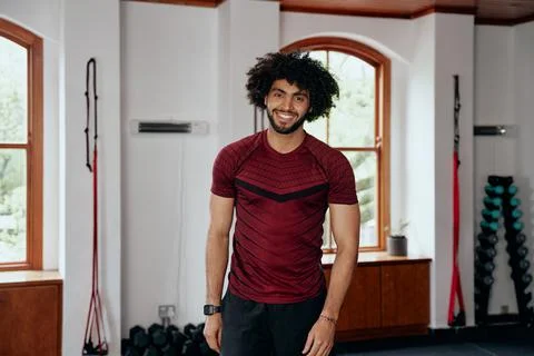 Three quarter length of happy young middle eastern man looking at camera at the Stock Photos